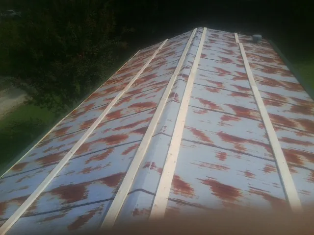 Rusted metal roof panels with new wood purlins before replacement — Storm Damage Roof Repair in Winamac by Roofing Brothers
